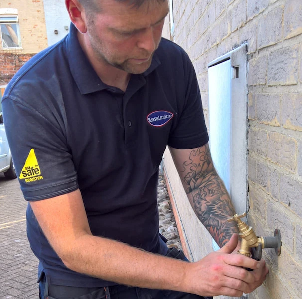 Plumber installing outside tap
