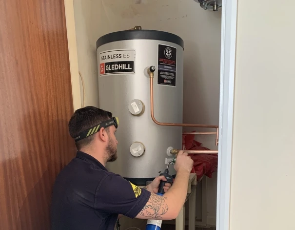 Plumber installing outside tap